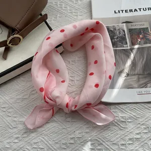 Detail of pink silk scarf with red polka dots and soft 80-count yarn texture