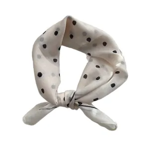 Elegant white polka dot silk scarf tied in a bow knot with premium satin finish
