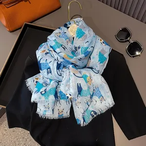 Detailed close-up of light blue silk cotton scarf featuring cute cartoon cat prints