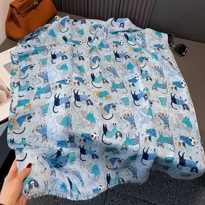 Close-up of cat print scarf with frayed edges and artistic winter snowflake pattern