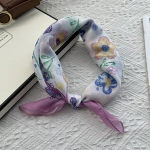 Detailed macro view of floral cotton linen neckerchief with blue and purple hand-drawn flowers