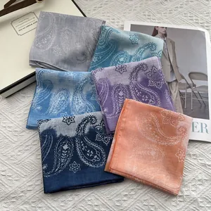 Five assorted paisley cotton linen square scarves displayed in a fan-shaped stylish layout