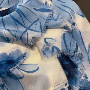Detail shot of the frayed edges and breathable floral texture of this cotton linen shawl