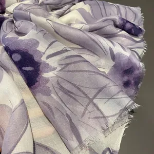 Close-up of purple daisy pattern and raw edge fringe on soft cotton linen scarf