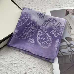 Detail shot of purple paisley cotton linen scarf with gradient pattern and hemmed edges