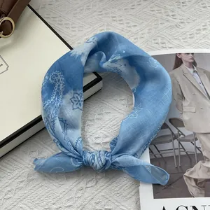 Detail of blue paisley cotton linen scarf with elegant patterns and smooth edges