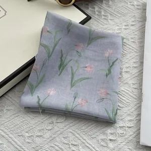 Detailed texture of lightweight lavender floral silk scarf with tulip pattern on lace