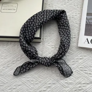 Elegant 55cm black and white paisley print square scarf tied in a stylish loop