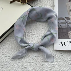 Detailed view of light purple silk scarf with pink tulip floral print and delicate edges