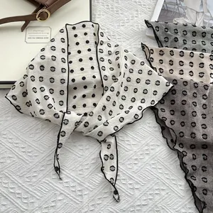 Polka dot cotton linen scarves in various colors with black edges on white textured background
