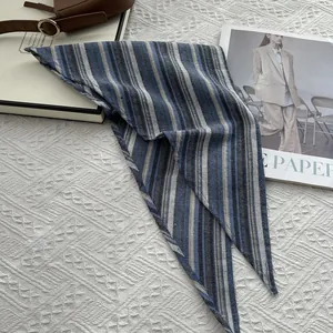 Detail showing high-quality cotton texture and classic striped pattern on the scarf