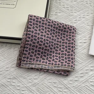 Pink paisley silk square scarf 55cm with black floral print on white textile background