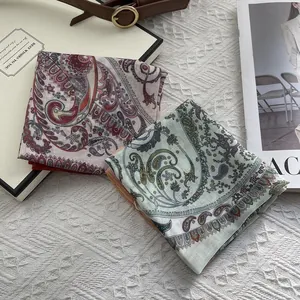 Elegant cotton linen square scarf with paisley pattern on white textured fabric backdrop