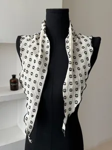 Close-up of vintage polka dot cotton linen scarf with black edge stitching and texture