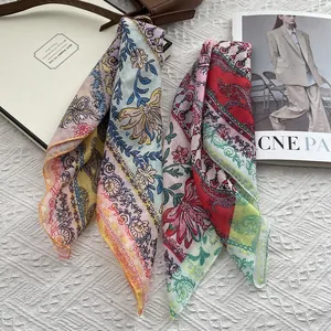 Elegant floral and paisley print square scarves in vibrant yellow and blue chiffon texture