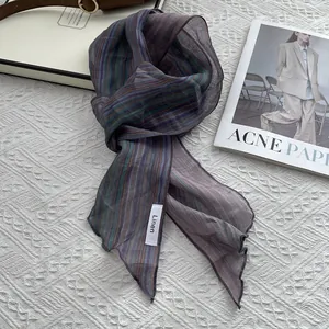 Close-up of lightweight purple striped linen scarf with delicate wavy hem edges