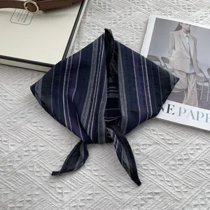 Detailed view of striped cotton neck scarf texture with minimalist knotted design