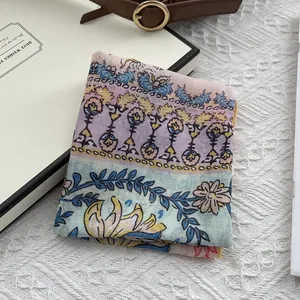 Close-up of a floral cotton linen scarf with ethnic patterns on a vintage table