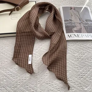 Detailed texture of brown plaid linen scarf on a vintage style fashion magazine setup