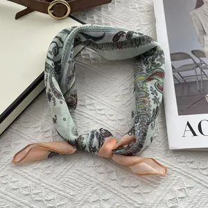 Detail of soft cotton linen paisley scarf showing light breathable texture and knot tie