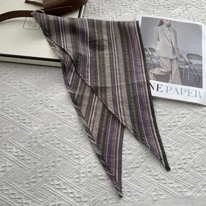 Macro view of purple and grey striped cotton scarf with refined hemmed edges