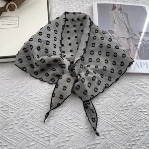 Close-up of a knotted retro polka dot cotton linen scarf on a magazine background