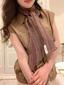 Detail of colorful striped linen skinny scarf with fine edge stitching for women