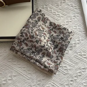 Paisley pattern vintage square scarf in beige and rust red on waffle fabric background