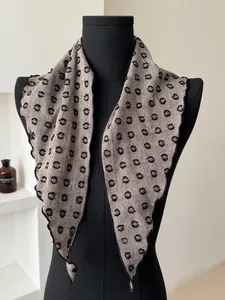 Detailed view of the vintage polka dot cotton linen scarf with fine black edge stitching