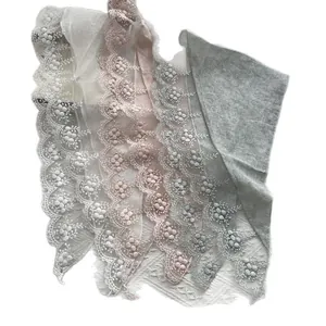 Lace mesh triangle scarf with floral embroidery and pom-pom trim in multiple soft colors