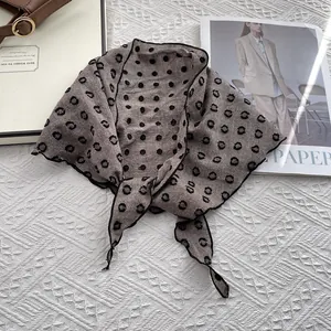 Close-up of brown cotton linen scarf with black polka dots and fine edge stitching