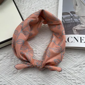 Detail of floral cotton linen neckerchief with hand-painted leaf pattern on white background