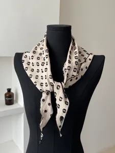 Detailed view of polka dot linen scarf showing delicate hem and textured lightweight fabric