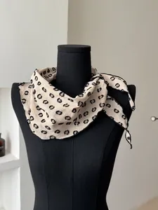 Detailed view of polka dot cotton linen scarf tied on a mannequin neck accessory