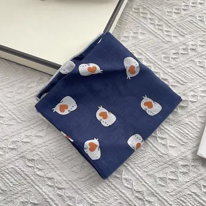 Navy blue cotton square scarf with white seal and orange heart pattern on knitted cloth