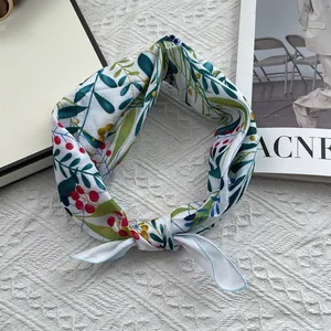Detail of floral linen headscarf with botanical prints and a decorative knot detail