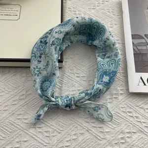 Teal paisley print cotton linen small square scarf with stylish knot on knit background