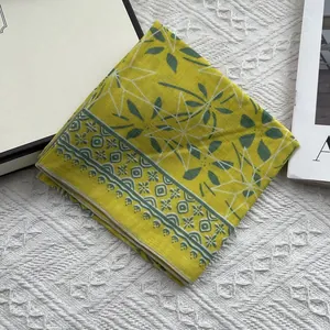 Detail view of the floral cotton linen scarf edges and lemon yellow fabric pattern