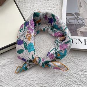 Detailed view of floral cotton linen scarf with yellow hem edges and soft floral patterns
