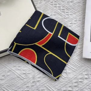 Detail of floral cotton linen neckerchief with black base and abstract geometric patterns