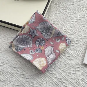 Detailed view of pink cotton square scarf with white sea shell and starfish prints