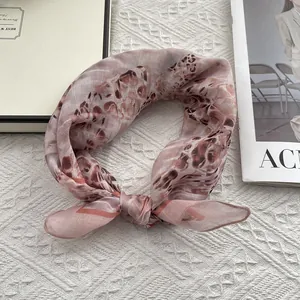 Detail of pink leopard print chiffon scarf with lightweight woven texture for styling