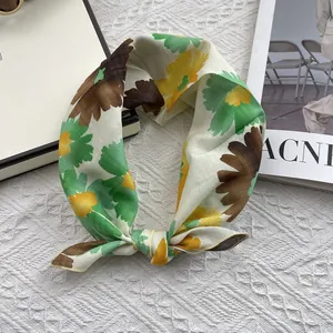 Detailed texture of a floral cotton linen scarf featuring vintage patterns and soft fabric
