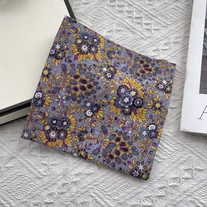 Detailed close-up of floral cotton-linen square scarf with vintage botanical patterns