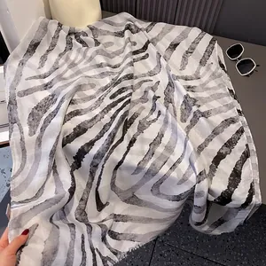 Detail of soft zebra print scarf showing black and white gradient fringe and fabric texture