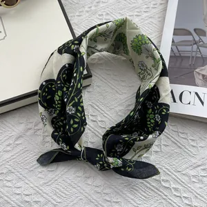 Detail of floral cotton linen neck scarf featuring a delicate green and white daisy pattern