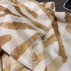 Close-up of thin gradient cotton scarf showing artistic stripes and fringe details