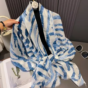 Detail of blue abstract stripe pattern on lightweight cotton sun protection scarf