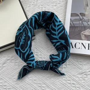 Detailed view of floral cotton linen neckerchief with leaf patterns and elegant knot