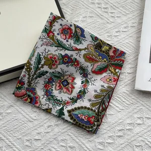 Detailed flat lay of floral cotton linen square scarf with paisley patterns